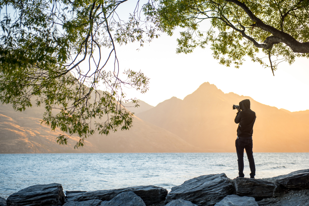 Young,Male,Photographer,Taking,Photo,Under,The,Tree,At,Lake | Luminarneo Blog