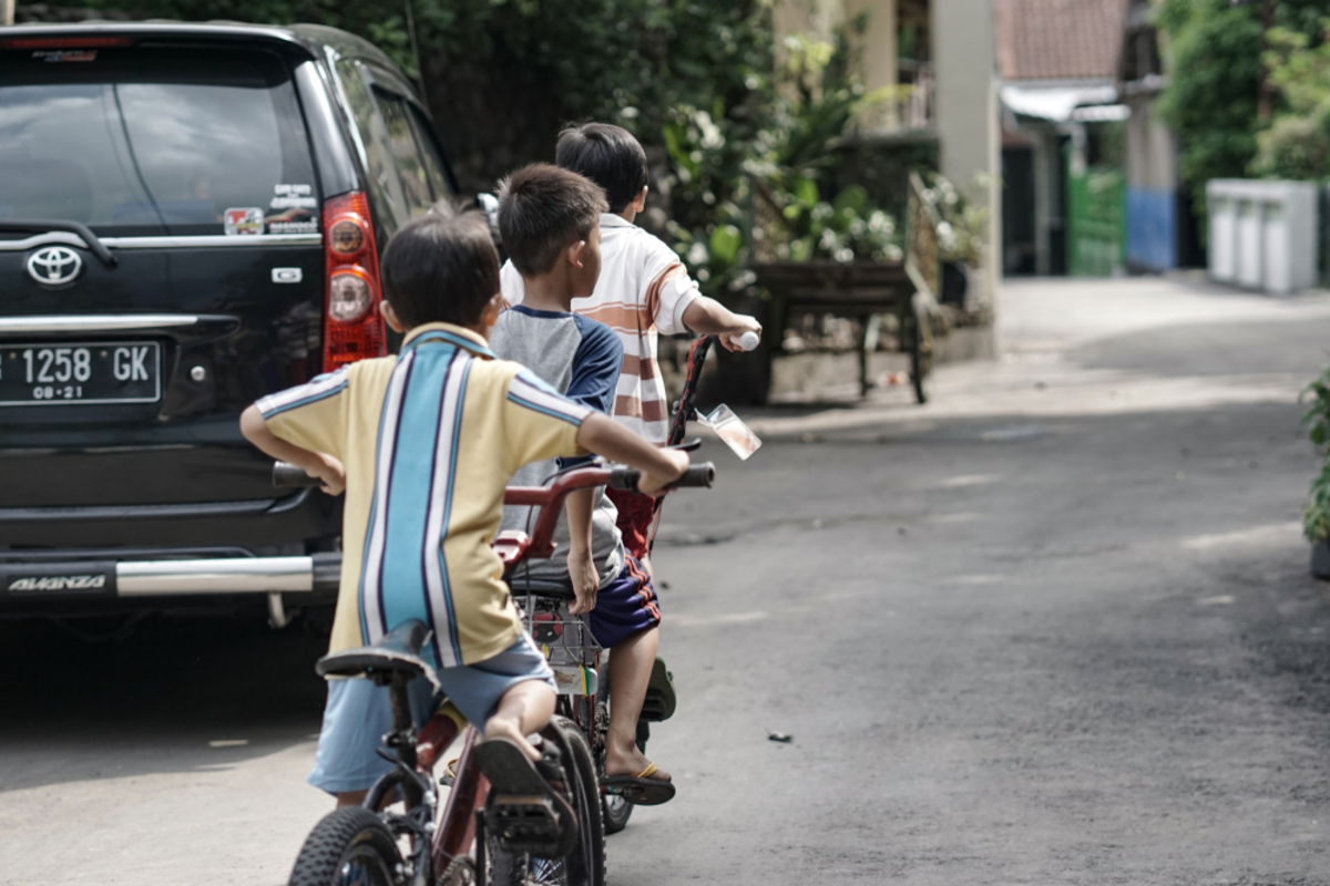 Jungen fahren mit Fahrrädern auf der Straße | Luminar Neo Blog