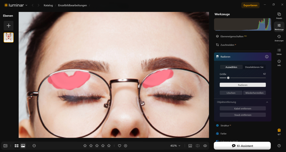 Luminar Radieren-Werkzeug mit pinker Maske über Brillenglas-Reflexionen im Porträt | Luminar Blog