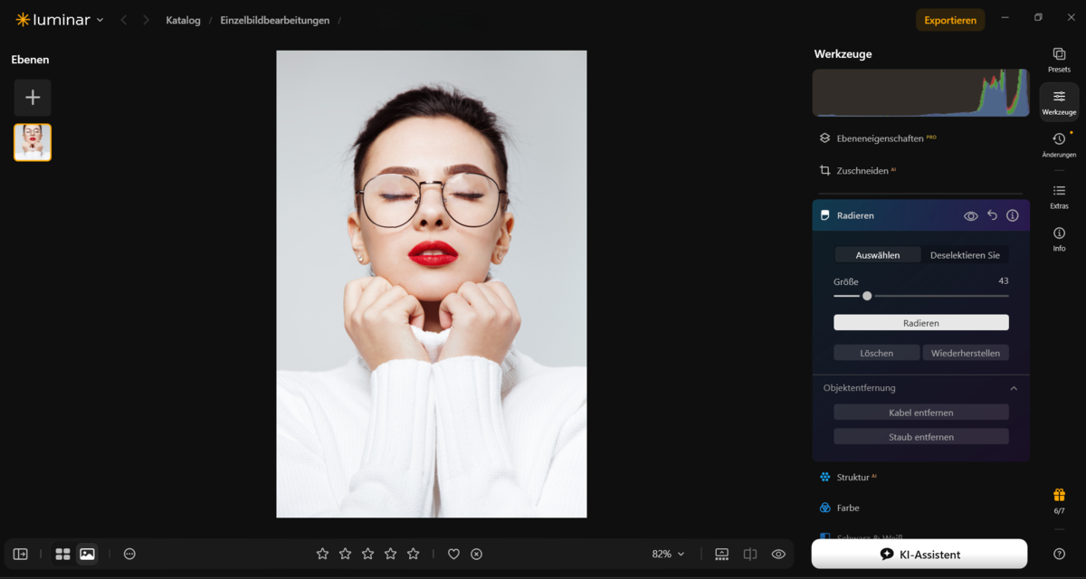 Luminar Werkzeugleiste mit geöffnetem Radieren-Tool auf Porträt einer Frau mit Brille | Luminar Blog